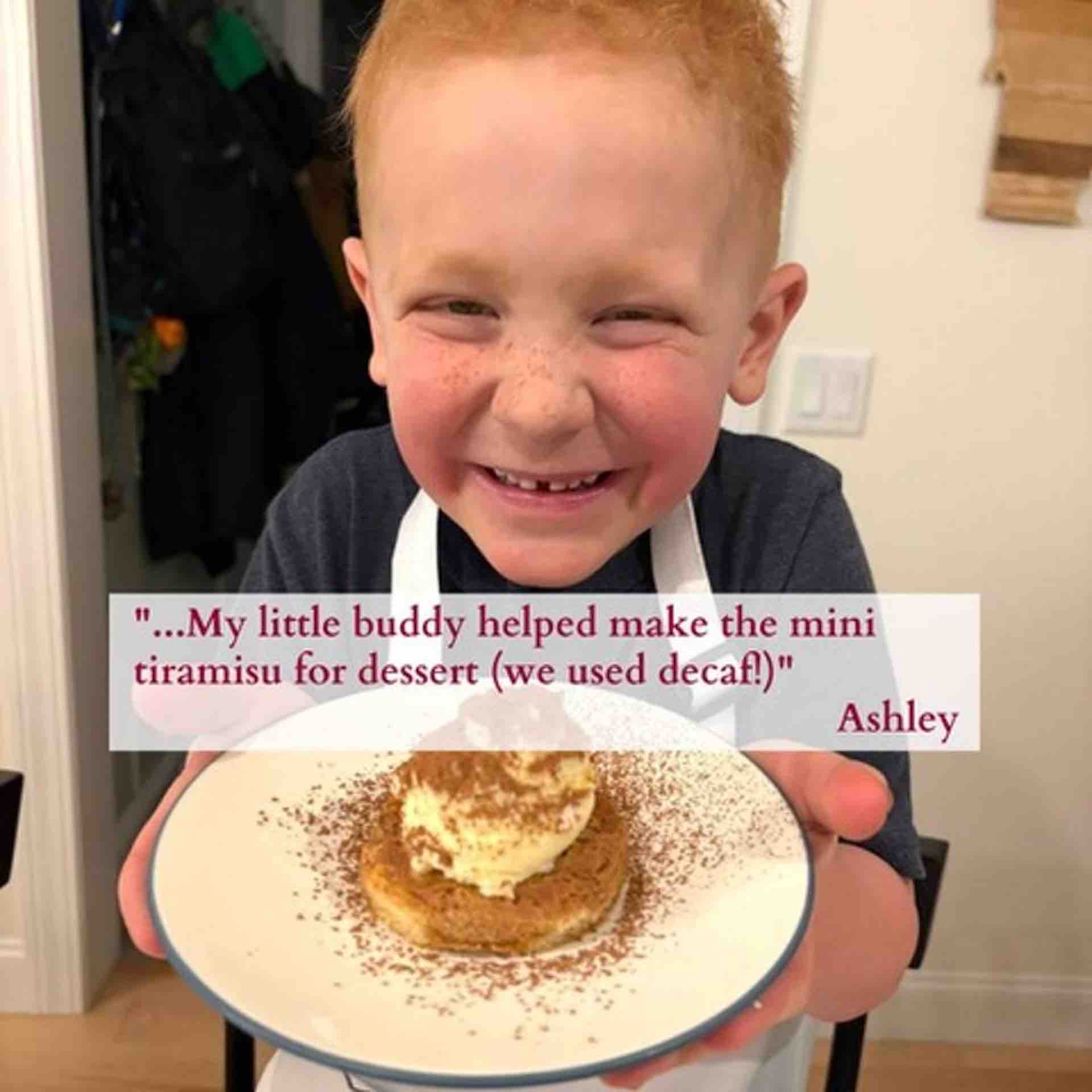 Child holding homemade mini tiramisu Italian dessert from cooking class