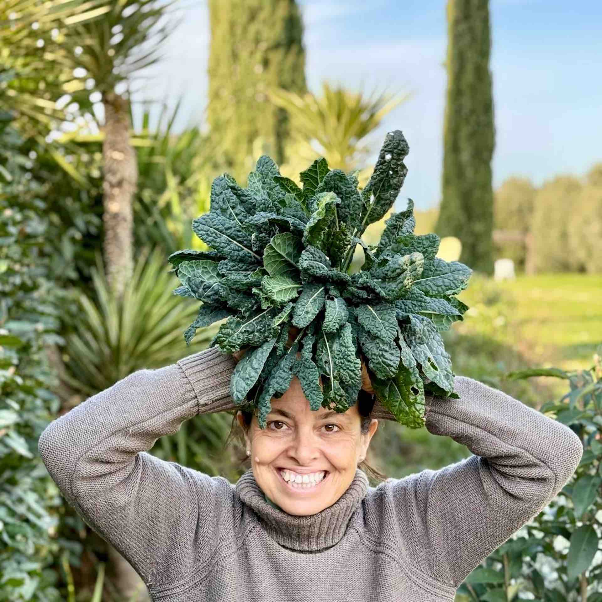 Chicca at Winter garden harvest in Tuscany with fresh herbs and greens